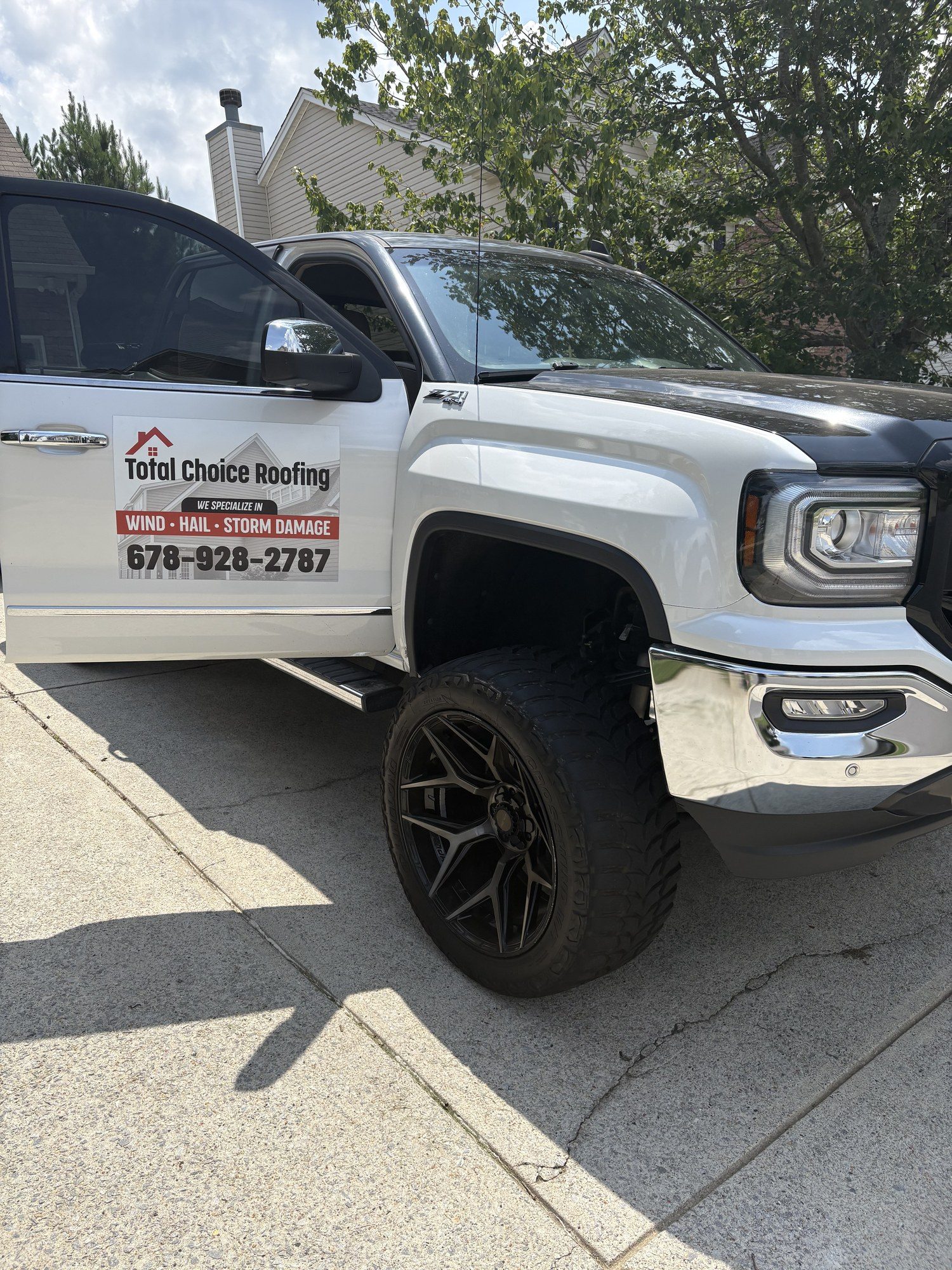 Total Choice Roofing branded truck on a job in Suwanee, GA